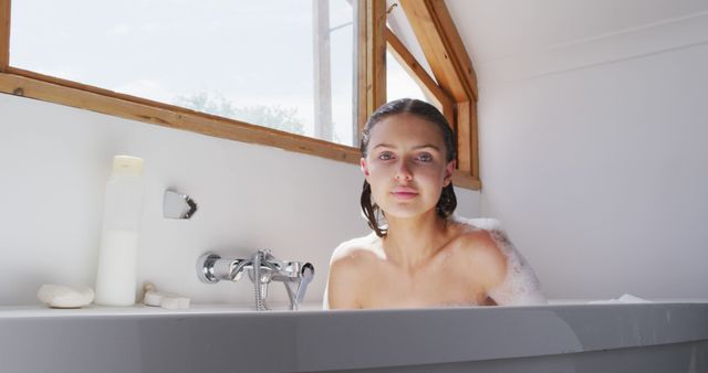 Serene Woman Enjoying a Relaxing Bubble Bath in Brightly Lit Bathroom - Download Free Stock Images Pikwizard.com