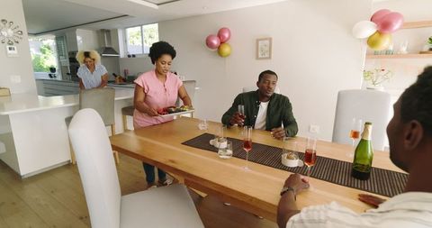 Friends Enjoying Relaxing Day at Home with Drinks and Laughter