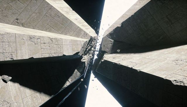 Concrete monoliths revealing central fissure shedding debris under dramatic backlight