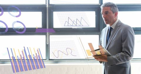 Businessman Analyzing Data Visualizations in Office Setting