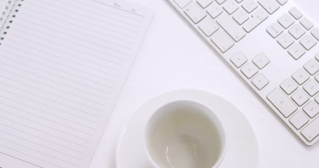 Clean Workspace with Keyboard, Empty Coffee Cup, and Lined Notebook - Download Free Stock Images Pikwizard.com