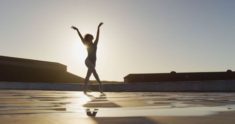 Graceful Sunset Rooftop Dance Against Glittering Sky - Download Free Stock Images Pikwizard.com