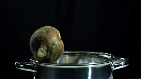 Turnip Falling Into Stainless Steel Pot in Slow Motion