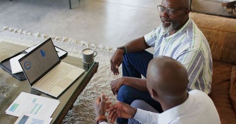 Financial advisor and client reviewing strategy at home