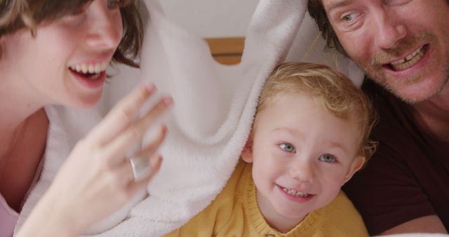 Cheerful Family Playing Together in Bed - Download Free Stock Images Pikwizard.com