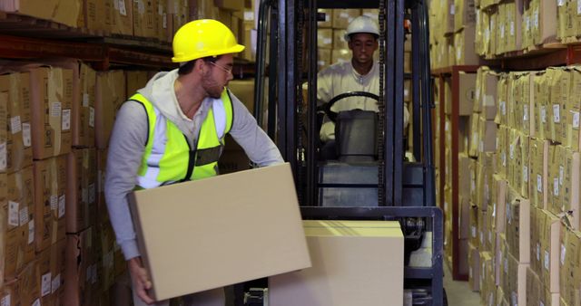 Workers in a warehouse stacking and moving boxes using a forklift. Ideal for illustrating concepts related to logistics, warehousing, manual labor, distribution, safety regulations, and teamwork.