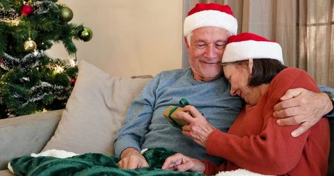 Senior Couple Celebrating Christmas Holding Gift