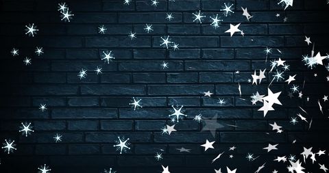 Falling Snowflakes and Stars on Dark Brick Wall