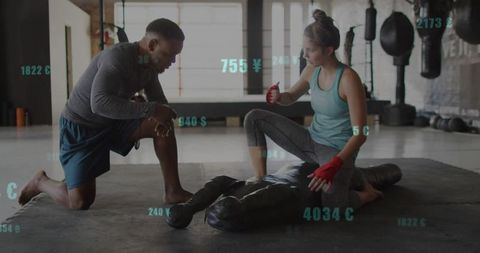 Training partners practicing grappling skills at modern gym