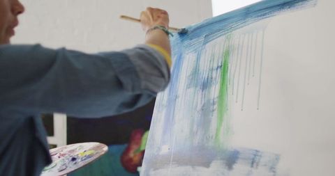 Artist Painting on Canvas in Sunlit Studio