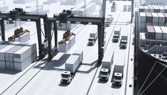 Aerial port logistics with gantry cranes loading containers onto trucks at busy terminal