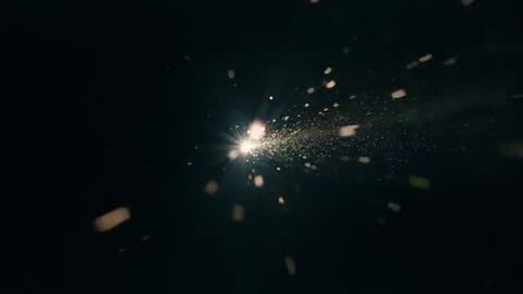 Cinematic Spark Burst Emitting Luminous Particle Trail Across Dark Cosmic Void