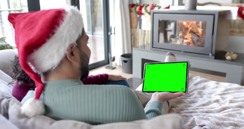 Festive Couple Enjoying Video Call by Cozy Fireplace with Tablet
