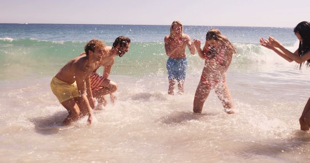 Group of Friends Enjoying Splashing Water at the Beach - Download Free Stock Images Pikwizard.com