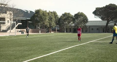 Soccer Players Walking on Field During Sunny Team Practice