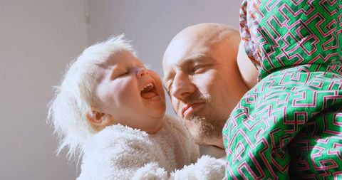 Father Experiencing Joyful Moments with Children at Home