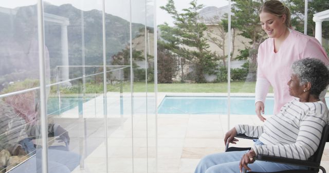 Caretaker assisting elderly woman in wheelchair with scenic mountain view - Download Free Stock Images Pikwizard.com