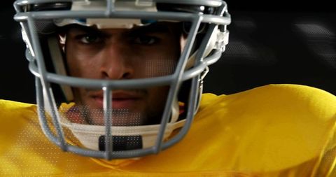 Focused American Football Player in Yellow Jersey