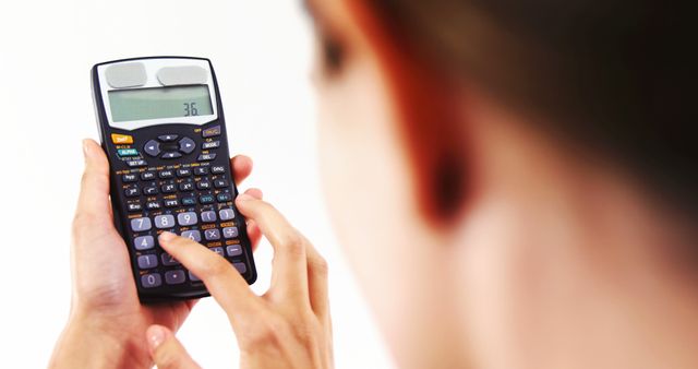 Perfect for educational or business purposes, featuring a person calculating with a scientific calculator. Ideal for illustrating concepts in finance, mathematics, science, or academic studying. Useful in textbooks, financial planning documents, or business presentations.