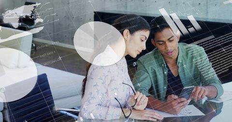 Team analyzing financial data with digital overlay in modern office