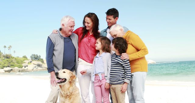 Multigenerational family group standing together on a sunny beach, smiling and interacting happily. Young children enjoying time with their parents and grandparents. Labrador dog part of the scene, adding warmth. Great for concepts like family time, vacation, outdoor fun, intergenerational bonding.