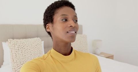 Woman Taking Smartphone Selfie Relaxed in Cozy Bedroom