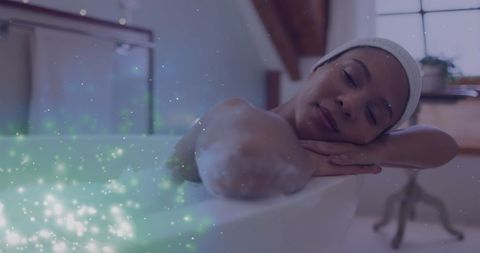African American Woman Relaxing in Bath with Magical Light Spirals