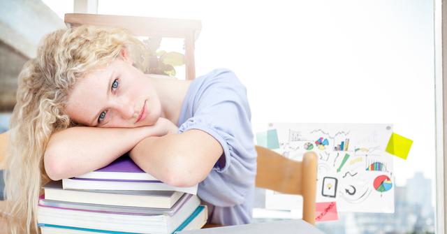 Digital composition of a girl resting her head on stack of books in classroom