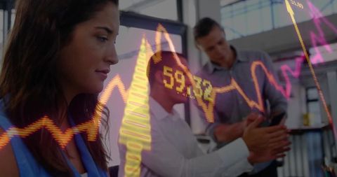 Business team analyzing data with stock market chart overlay