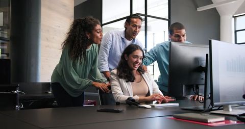 Diverse Team Collaborating and Celebrating in Modern Office