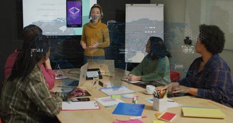 Woman presenting mobile app prototype to diverse team in boardroom meeting with flipchart