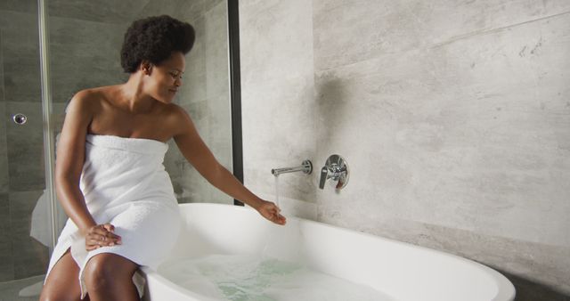 Happy african american woman preparing bath in bathroom - Download Free Stock Photos Pikwizard.com