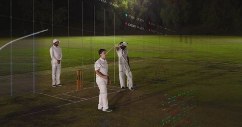 Cricket players standing on night pitch adjusting helmet with hud analytics overlay
