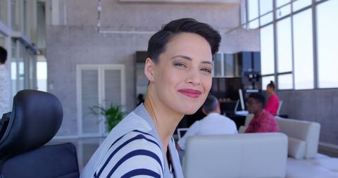 Confident businesswoman smiling in modern workplace