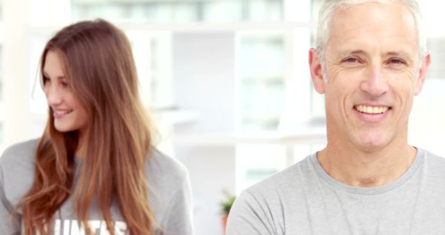 Smiling Older Man with Young Woman in Blurred Background, Indoors - Download Free Stock Images Pikwizard.com