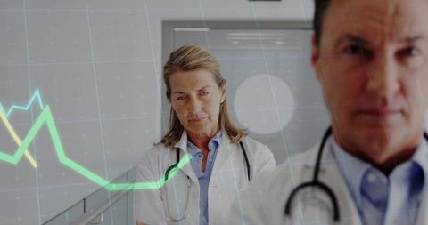 Doctors Analyzing Clinical Data with Downward Trend Graph in Corridor
