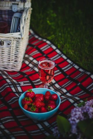 Vibrant Picnic Scene with Strawberries and Sparkling Wine
