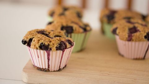 Freshly baked blueberry muffins on wooden tray