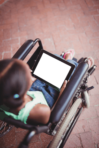 Transparent Tablet Use by Young Girl in Wheelchair Outdoors - Download Free Stock Videos Pikwizard.com