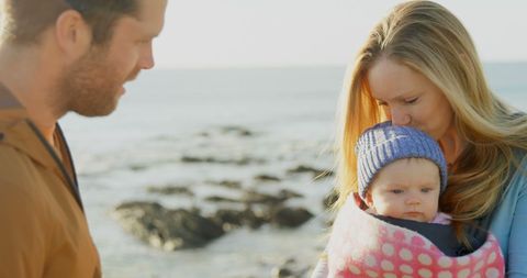 Family with Baby Enjoying Tranquil Day at Beach