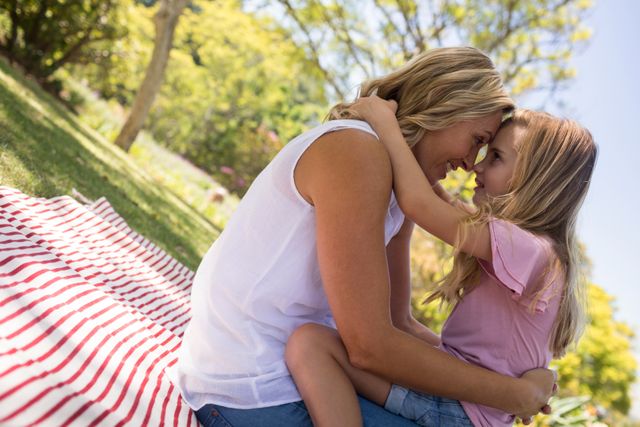 Happy Mother Embracing Daughter in Park on Sunny Day - Download Free Stock Photos Pikwizard.com