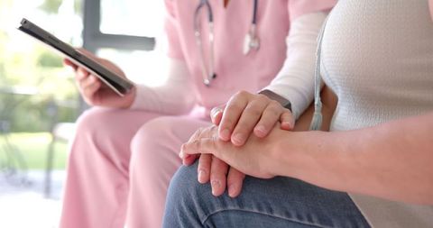 Nurse comforting patient with emotional support during home visit