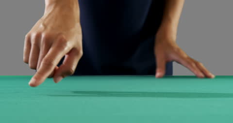 Close-Up of Businesswoman's Hand Gesturing Over Green Surface
