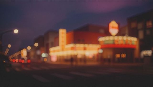 Blurred neon cityscape with glowing lights at night
