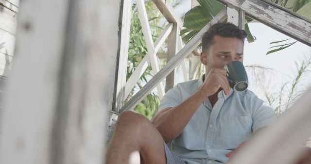 Man Enjoying Coffee on Tropical Veranda - Download Free Stock Images Pikwizard.com