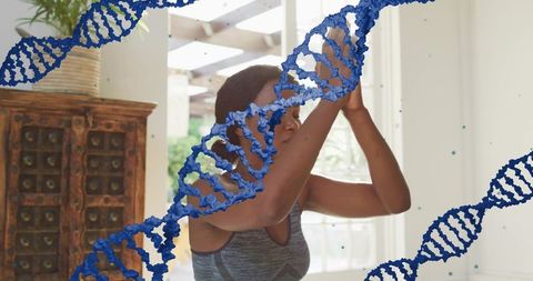 Sunlit home wellness woman stretching and raising arms with dna helix overlay, yoga fitness
