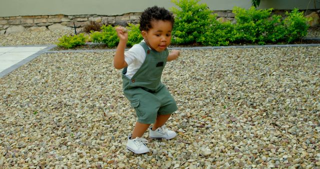 Happy African American Toddler Playing on Gravel Patio - Download Free Stock Images Pikwizard.com