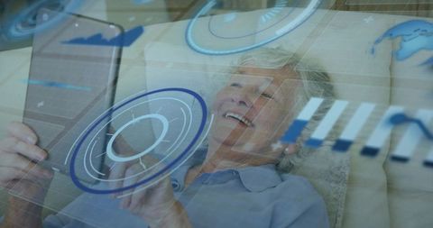 Elderly woman using tablet with futuristic digital interface