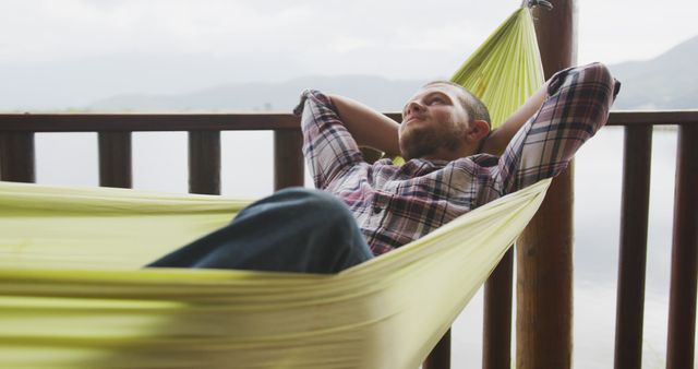 Relaxed Man Sitting in Hammock on Balcony Daydreaming - Download Free Stock Photos Pikwizard.com