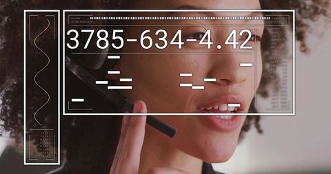 Customer support agent adjusting headset with ar data overlay, futuristic call center